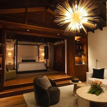 Royal Isabela Hotel Exterior photo This is a luxurious and richly designed interior photo, likely from a high-end hotel or modern, upscale residence.

The room features a dramatic and elegant aesthetic, combining warm wood tones with contemporary, sophisticated furnishings.

**Key ele